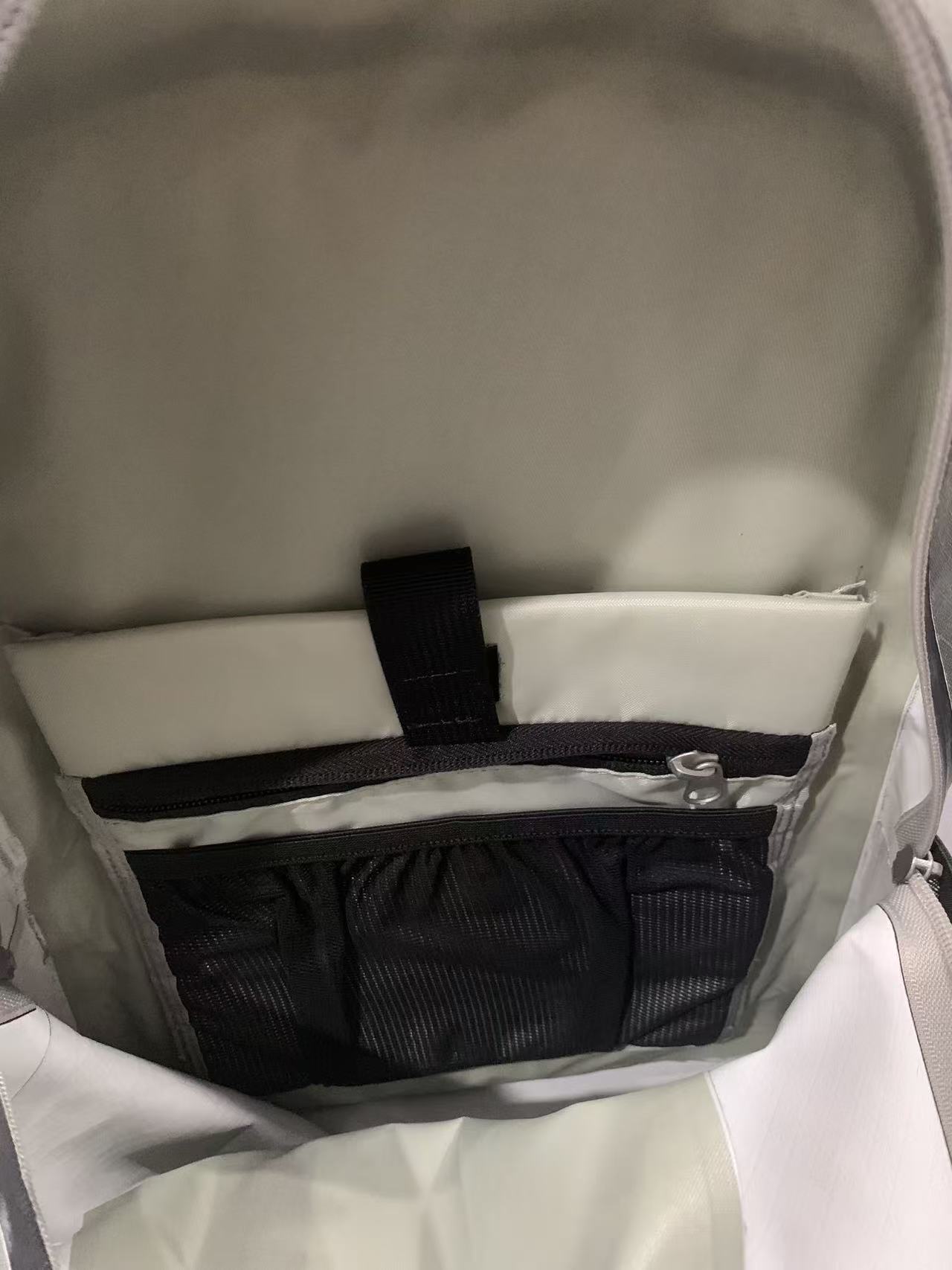 Waterproof commuter backpack interior showing the laptop compartment raised off the base